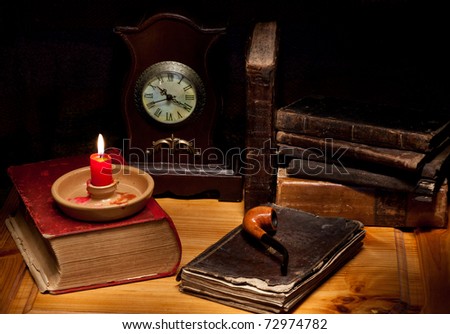 still life with old books, clock, candle and pipe