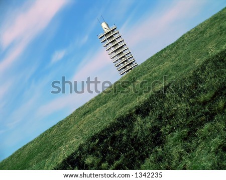 Floodlight tower between sky and Earth