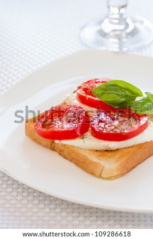 Bread with mozzarella tomatoes and basil leaves