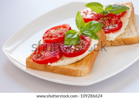 Fresh and tasty toast bread with mozzarella tomatoes and basil leaves