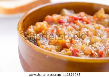 Close up off eggplant caviar in the rustic bowl. Ukrainian cuisine.