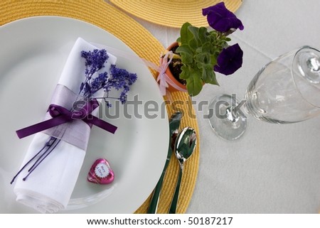 stock photo Purple or violet wedding place setting with yellow place mats
