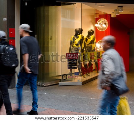 Men and mannequins in yellow in Amsterdam shopping quarters