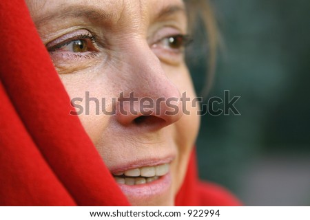 a middle aged woman wrapped in a shawl and looking to the right.