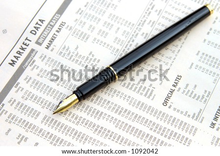 a fountain pan on top of a financial newspaper\'s page with currency exchange.