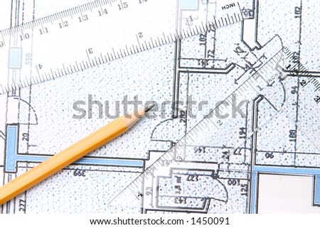 Yellow pencil and setquare and protractor on top of a blue floor plan.