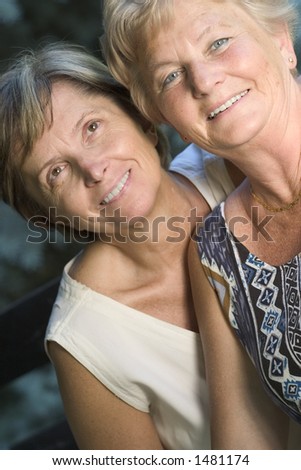Two sisters smiling. Focus on the lady on the right side.