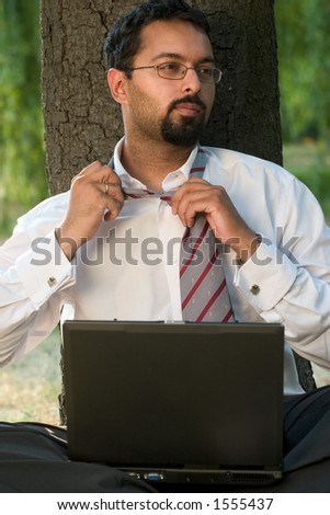 Indian businessman loosing up the tie.