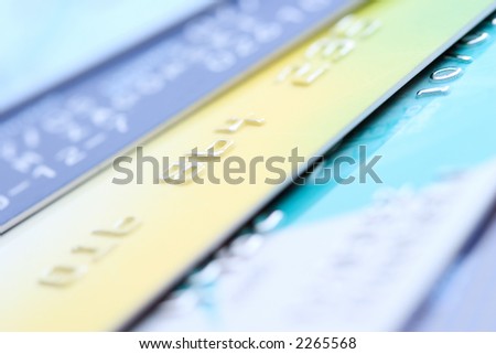 A stack of credit cards, close-up with shallow depth of field; focus on number \