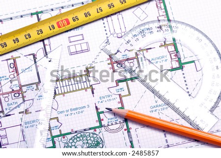 Top view of a tape measure, pencil and other tools on top of floor plan