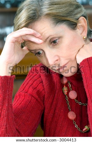 Mature woman with hand on head