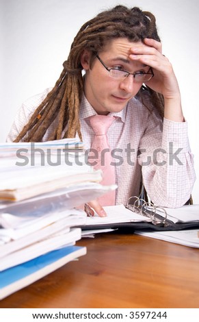 Young businessman being tired at work