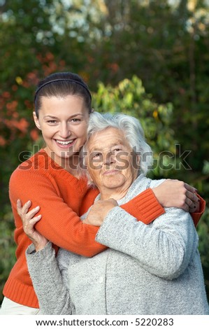Young woman hugging her ninety year old grandmother