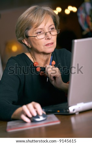 Mature woman using a laptop computer, portrait