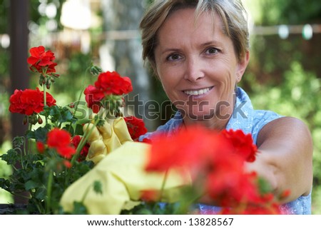 Mid adult woman taking care of flowers, portrait