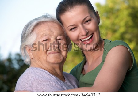 Grandmother and her granddaughter embracing each other.