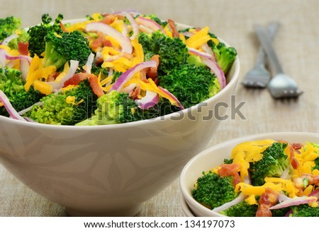 Steamed broccoli salad with bacon, cheese and red onion