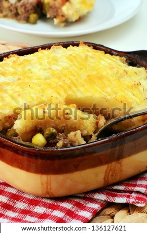Hot from the oven homemade shepherd\'s pie with cheesy mashed potatoes in small casserole dish
