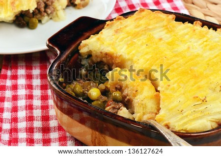 Hot from the oven homemade shepherd\'s pie with cheesy mashed potatoes in small casserole dish