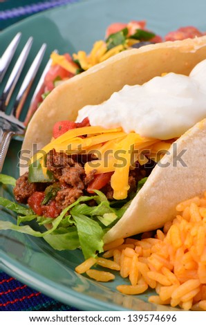 Soft tortilla with spicy ground beef, salsa , sour cream and cheese with Mexican rice