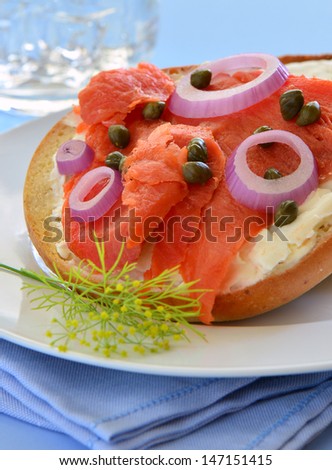 Smoked salmon lox with cream cheese capers and red onion on toasted Asiago cheese bagel