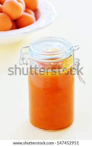 Fresh ripe apricots in a jar in vertical format