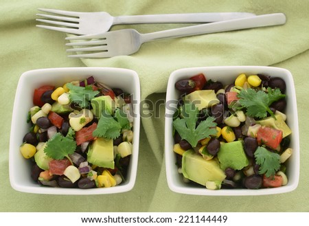 Black bean salad with avocado, corn, tomato, red onion and cilantro in horizontal format