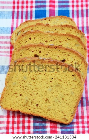 Gluten free sunflower seed bread on red, white and blue checked cloth