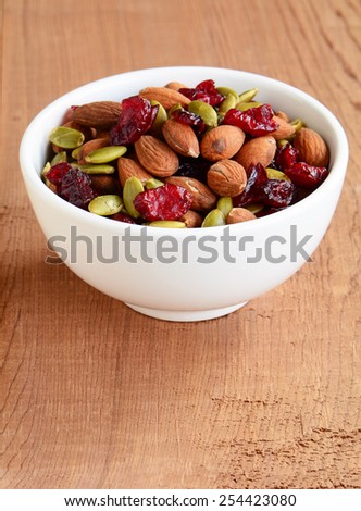Organic trail mix of roasted almonds, raw pumpkin seeds (pepitas) and dried cranberries for a healthy snack