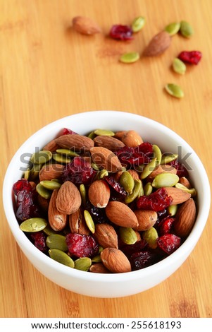 Organic trail mix of roasted almonds, raw pumpkin seeds (pepitas) and dried cranberries for a healthy snack