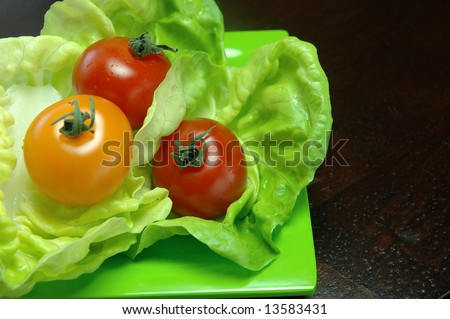 Fresh cherry tomatoes on butter lettuce