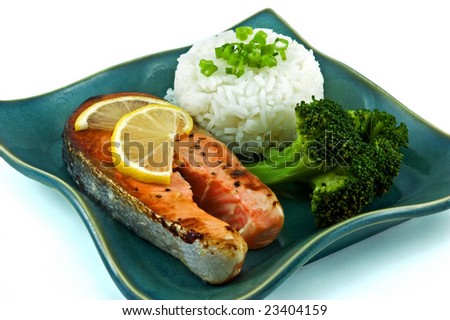 Healthy portion of fresh wild coho salmon with half cup of rice and steamed broccoli