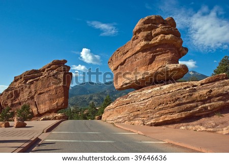 Balanced Rock formation at Garden of the Gods park with road going opening in the rock.  Garden of the Gods park is a Registered National Natural Landmark, located in Colorado Springs, Colorado