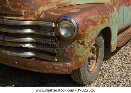 Vintage pickup truck with fading paint and rust