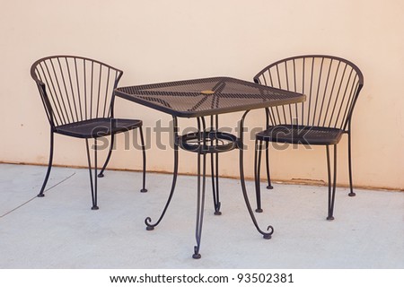 Wrought iron table and chairs outside sidewalk cafe waiting for customers to sit and dine