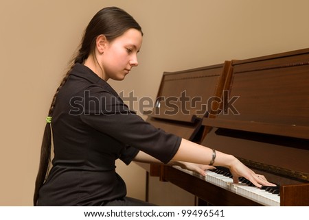 The girl playing the piano at the music school's office