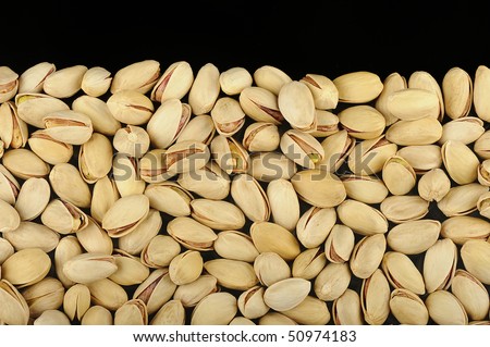 Pistachios arranged in a pile for a product photograph. Pista is grown mainly in Iran and the USA. They are considered to be a healthy snack.