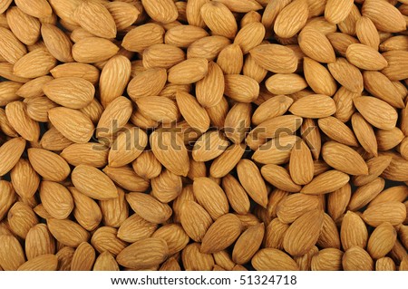 Numerous almonds arranged in a pie for a product photograph. Almonds are considered healthy and good for the heart.