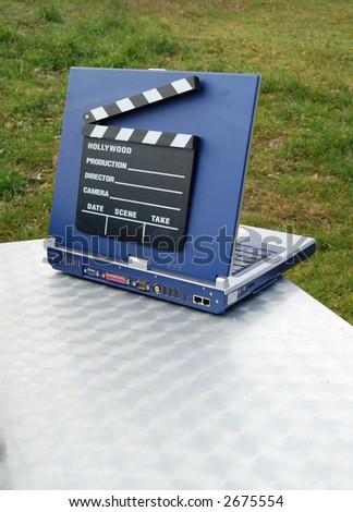 clapper-board on a laptop to represent digital movie making