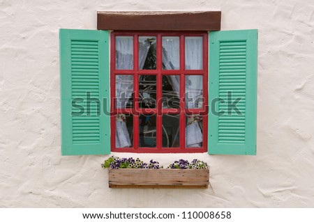 Vintage light green window on white cement wall