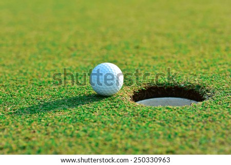 Close up of golf ball near the hole