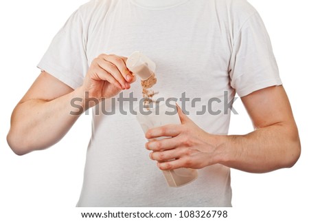 Man preparing his post workout protein shake with a scoop of chocolate whey isolate powder in the shaker isolated on white