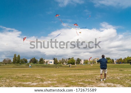 STEVESTON, CANADA - MAY 13, 2007: Unidentified man playing with kites on the Garry Point Park kite field. The park is large 75 acres waterfront park, located close to historic Steveston Village.