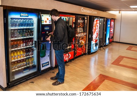 Vancouver, Canada - May 12, 2007: Unidentified Male Student Paying For The Drinks From The Vending Machine At Simon Fraser University Convenience Centre.