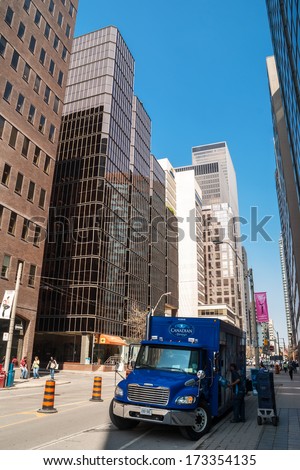 TORONTO, CANADA - MAY 10, 2007: Blue delivery truck in downtown Toronto, financial capital of Canada with 5 largest financial institutions of Canada situated in offices in Financial District.