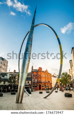 CARDIFF, UK - SEPTEMBER 8, 2010: Alliance, 25m high sculpture in Cardiff, Wales, consisting of stainless steel arrow column and hoop, that glows in dark, falling and rising with movement of tide.