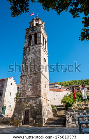 BLATO, CROATIA - AUGUST 9, 2010: Tower of the parish Church of All Saints located in the Blato on the Korcula island. The church was first mentioned in scripts dating back to 14th century.