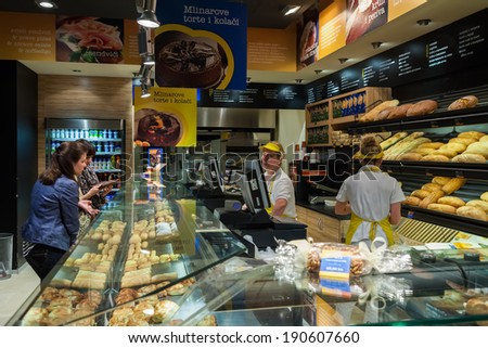 ZAGREB, CROATIA - JUNE 2, 2012: Unidentified girls ordering baked products in \'Mlinar\' bakery in Zagreb city center. Mlinar was established in 1903 and is leading Croatian baking company.