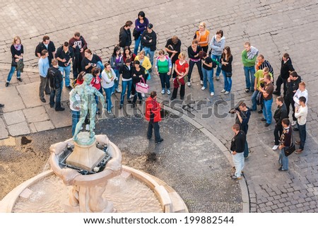 WROCLAW, POLAND - OCTOBER 7, 2009: Tourists with tourist guide gathered in front of Statue of Naked Fencer in front of University of Wroclaw. Statue was designed by Hugo Lederer and erected in 1904.