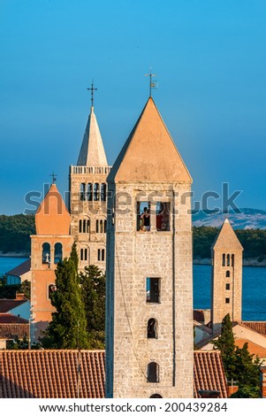RAB, CROATIA - AUGUST 24, 2009: Four church towers in historic city of Rab: Church of St. Justina, Belfry of  St. Mary's church, church of St. Andrew and Church and Convent of St. John the Evangelist